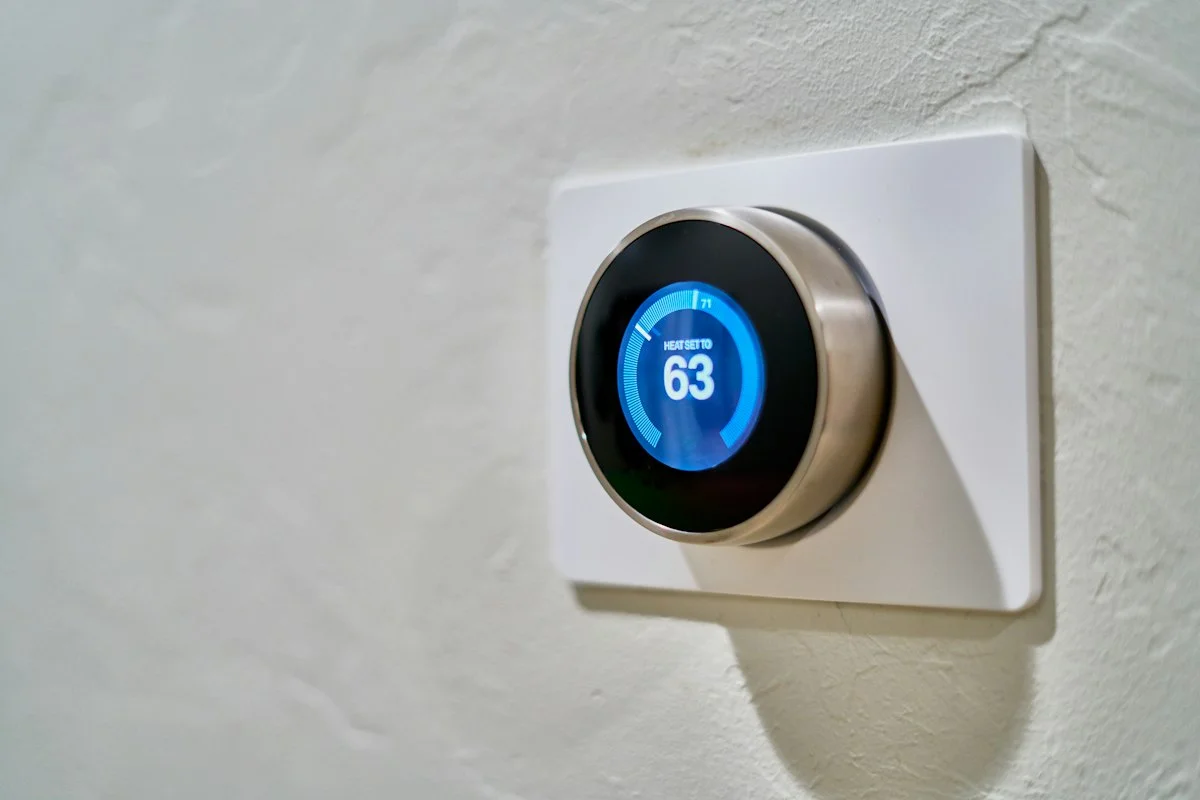Smart home digital thermostat displaying high efficiency heating settings in winter