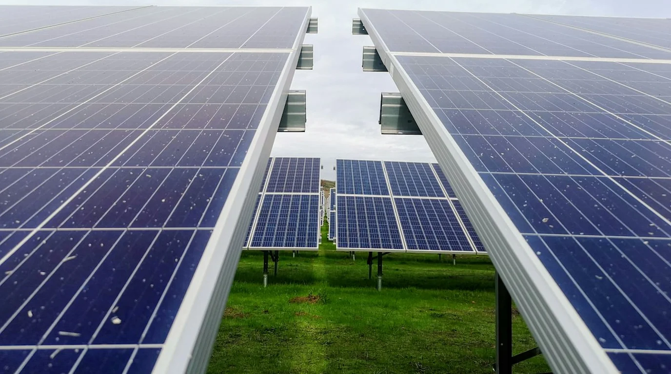 Rural Residential Property Comparing Modern Ground Mount Bifacial Solar Array to Rooftop Solar Panels
