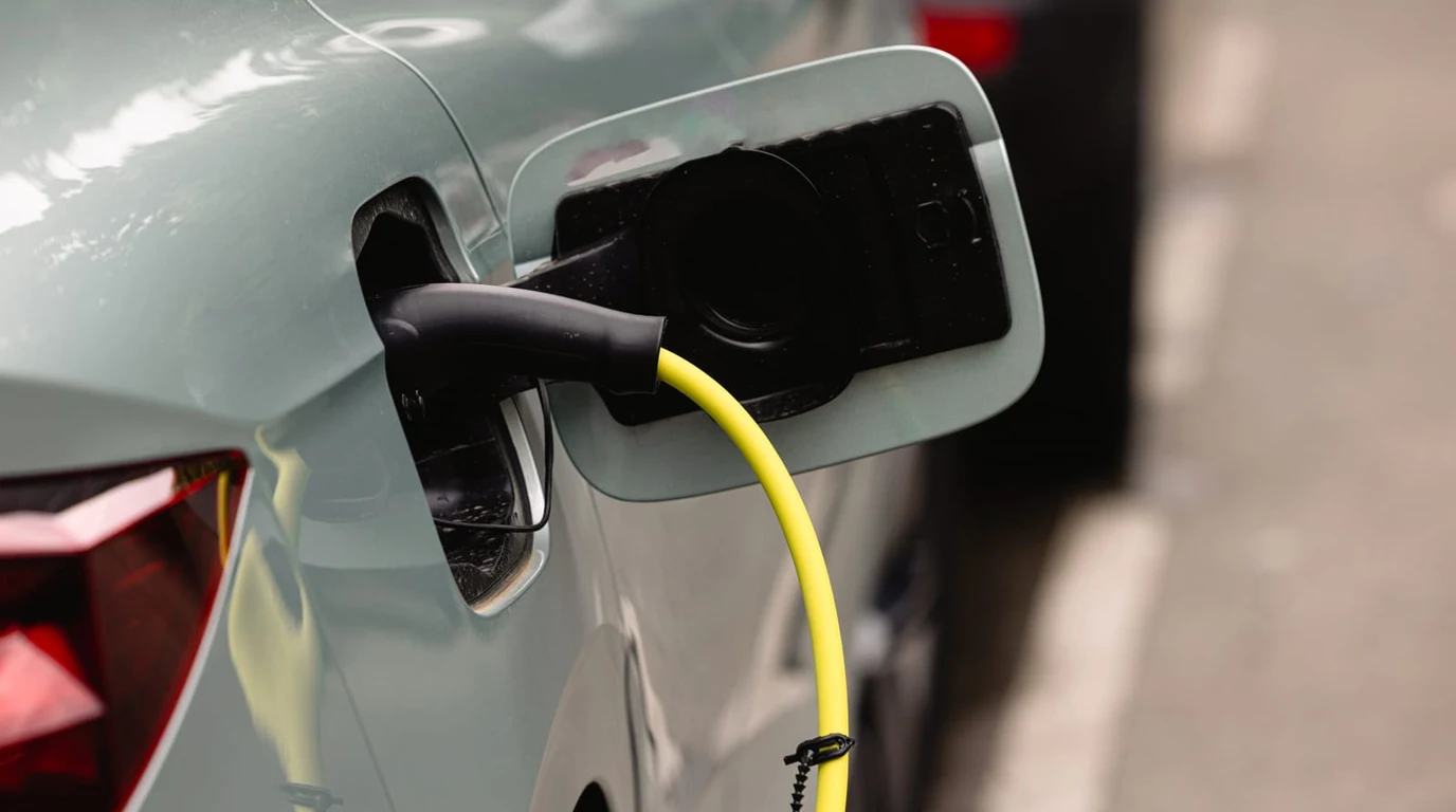 Modern Home Garage EV Charger with NACS J3400 Bidirectional V2H Cable Attached to Electric Vehicle