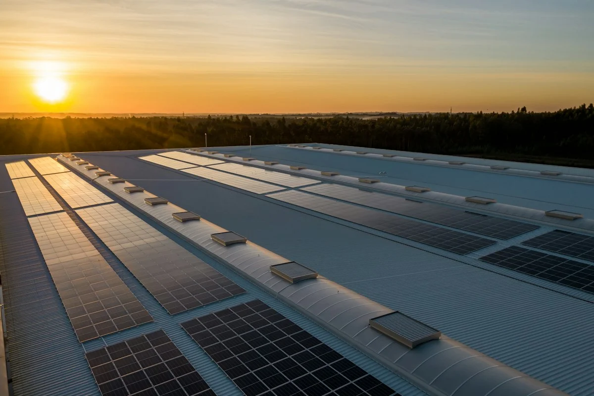 Architecturally integrated solar roof shingles installed seamlessly alongside asphalt roofing tiles on modern home
