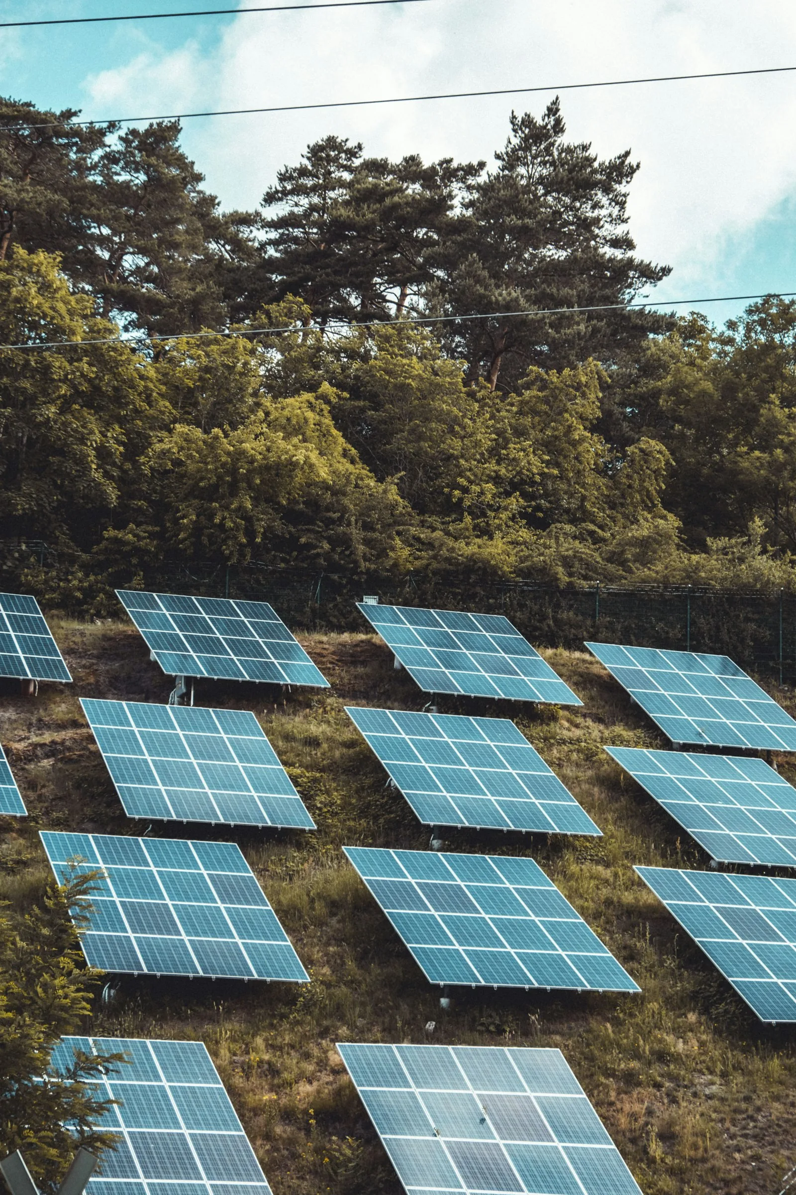 Rooftop solar photovoltaic panels installed with professional inverter cable management under clear sky